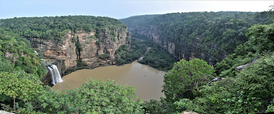 Devdari waterfall cascading over a sandstone cliff into a canyon pool ringed by forested gorge walls, Chandauli, Uttar Pradesh