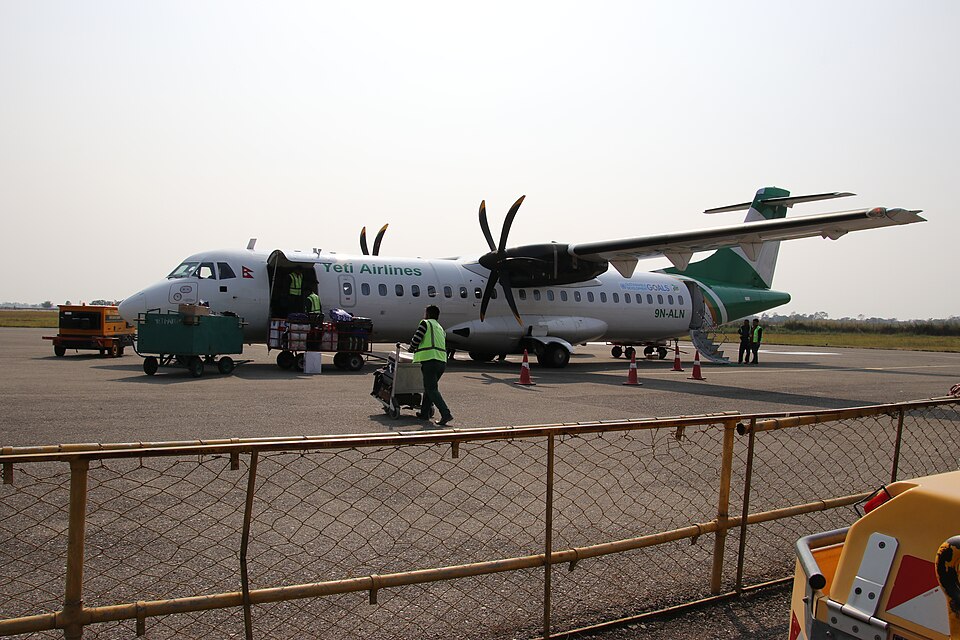 A Yeti Airlines ATR 72-500 twin-turboprop aircraft (registration 9N-ALN) parked on an airport apron with baggage being loaded
