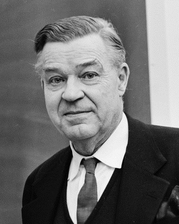 Black-and-white portrait of Swedish economist Gunnar Myrdal in a dark suit and tie, photographed in 1964