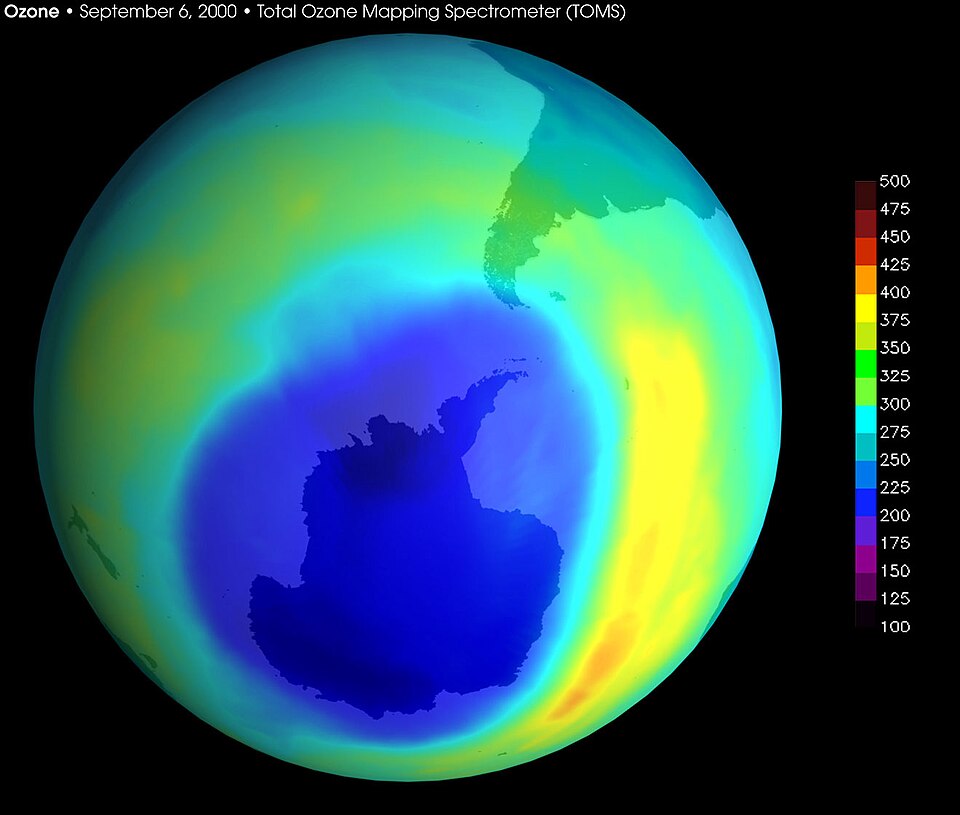 False-colour satellite map of total column ozone over Antarctica on 6 September 2000, showing a deep blue and purple region centred on the continent, with a Dobson Unit colour scale at the right